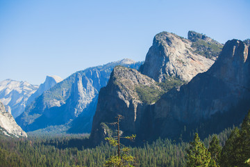 Beautiful summer view of Yosemite Valley , with El Capitan mountain, Half Dome mountain, Bridalveil waterfall, seen from Tunnel View vista point, Yosemite National Park, California, USA