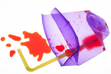 Crushed plastic purple cup with spilled juice