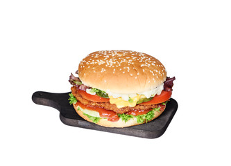 fresh tasty burger on a wooden cutting board isolated on white background