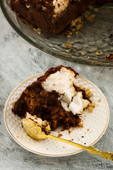 The remains of the chocolate cake. Dinnerware for dessert. Light background. Vertical.