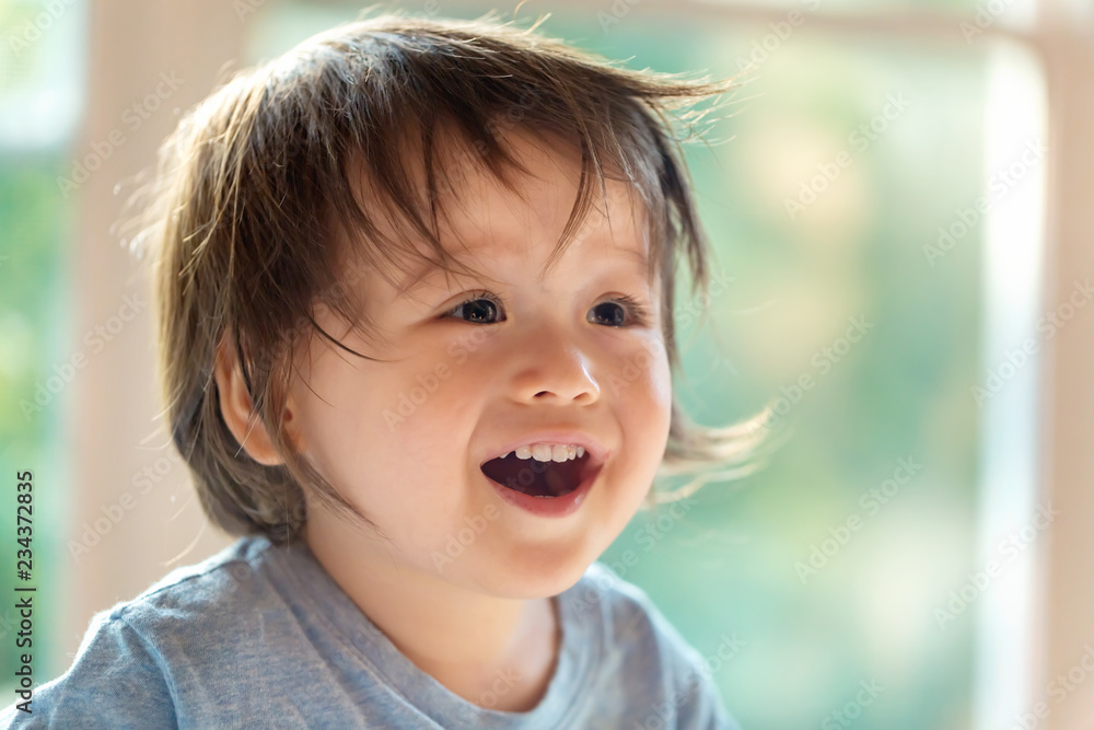 Wall mural Happy little toddler boy with a big smile