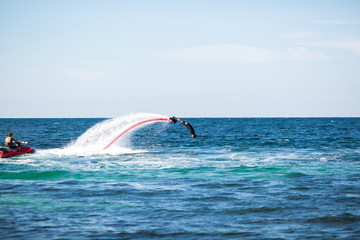 Fototapeta premium Silhouette of a fly board rider at sea