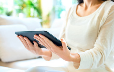 Young woman with a tablet computer in a bright interior room