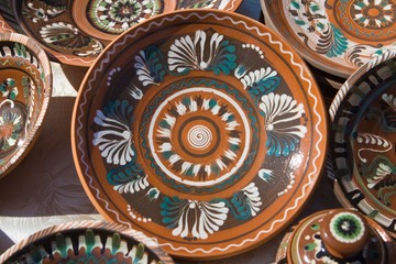 traditional Ukrainian ceramic clay plates, handmade and handpainted, bright floral and abstract pattern