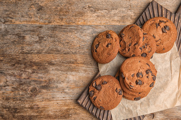 Chocolate chip cookies on wooden background, top view. Space for text