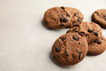 Tasty chocolate chip cookies on light background. Space for text