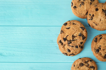 Tasty chocolate chip cookies on wooden background, top view. Space for text
