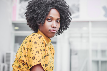 Young smiling dark-skinned woman dressed in casual clothes