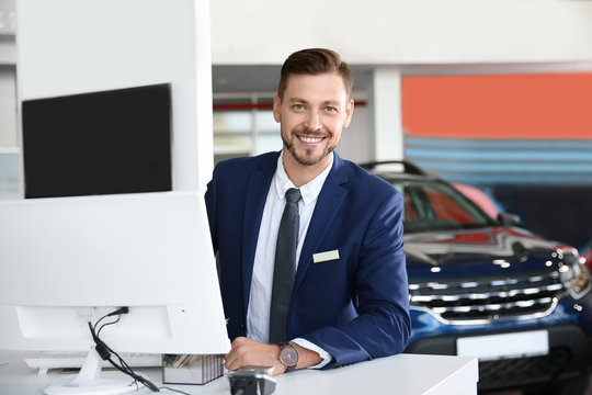 Salesman Working In Modern Car Dealership. Buying New Auto