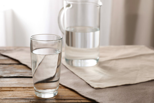 Glassware of fresh water on table indoors. Space for text