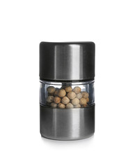 Manual grinder with peppercorns on white background