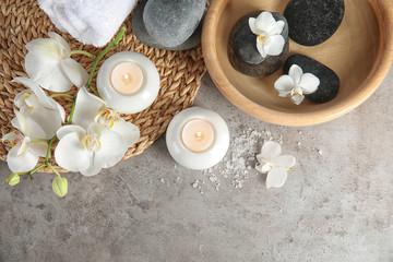 Flat lay composition with spa stones and candles on gray table