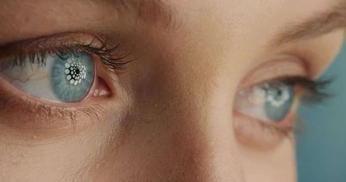 close up beautiful blue eyes opening blinking with light reflecting on iris macro healthy eyesight surgery concept
