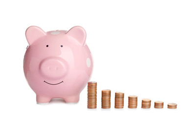 Piggy bank and different height coin stacks on white background. Space for text