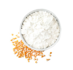 Bowl with corn starch and kernels on white background, top view