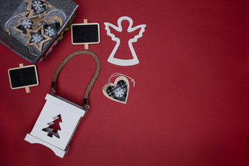 Christmas box, candle holder, heart, mini chalk board and wooden angel cutout. Conceptual minimalistic flat lay