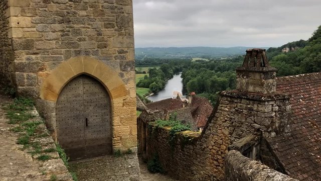 Beynac street view with old medieval buildings and a view over the river dordogne