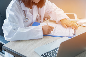 Healthcare medical concept. Woman Doctor writing prescription clipboard with record information...