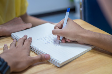 Asian Student note on notebook while learning study and writing for planning work. Studying in Education at university concept. Back to school