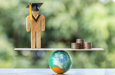 University Education learning abroad international Idea. Student Graduation save coins placed on mock globe with balance. Concept of study requires money cost saving for success. Back to School