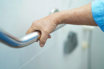 Asian senior or elderly old lady woman patient use toilet handle security in nursing hospital ward...