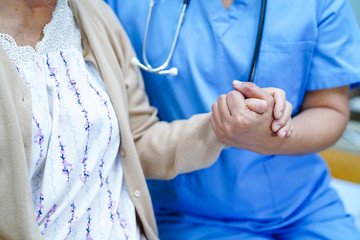 Asian nurse physiotherapist doctor care, help and support senior or elderly old lady woman patient...