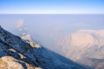 View towards Half Dome and the valley beyond on a day with low visibility due to the smoke coming from the Ferguson Fire, Yosemite National Park, California