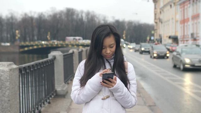 Young Asian Woman Walking Texting Cellphone Smart Phone In City