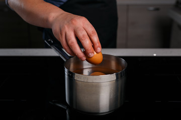 Chef removing an egg from water