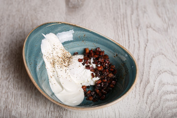 Boiled eggs with fried bacon and sour cream