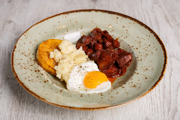 Romanian traditional food, polenta with fried egg and spicy meat