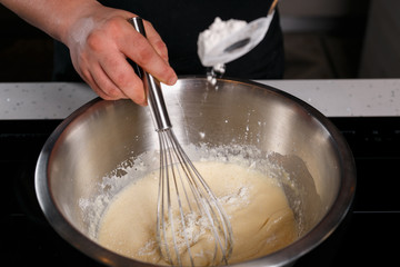 Chef adding flour and stirring