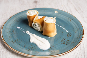 European pancakes, crepes, with cream cheese and sour cream