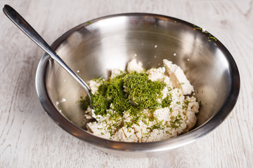 Cheese with cut dill on top