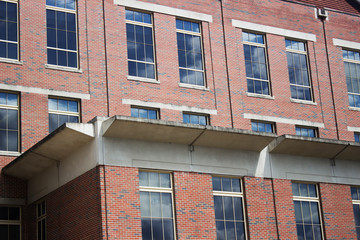 Brick building with sky reflection in glass windows