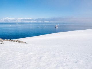 View from Spigot Peak to Gerlache Strait with small cruise ship, Antarctic Peninsula, Antarctica
