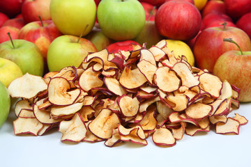 Naklejka na ściany i meble Dried Apple slices surrounded by fresh apples on white background