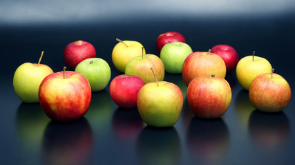 fresh different apples on dark background
