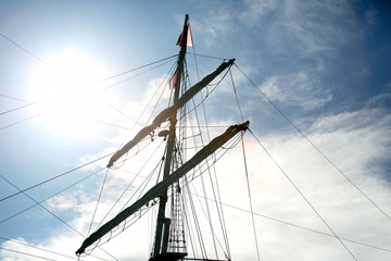 masts of the sailboat on the background of the sun