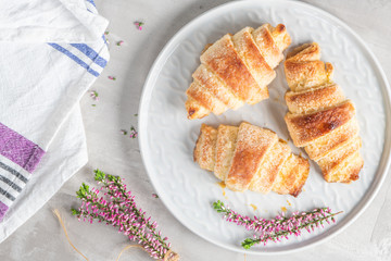 Tasty buttery croissants on plates. Flat layer.