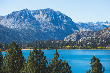 Fototapeta na wymiar Beautiful vibrant panoramic view of June Lake, Mono County, California, with Mountains of Sierra Nevada and Carson Peak in the background, United States