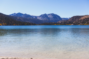 Obraz premium Beautiful vibrant panoramic view of June Lake, Mono County, California, with Mountains of Sierra Nevada and Carson Peak in the background, United States