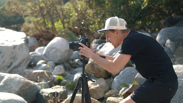 Male setting up camera and tripod to capture the beauty of nature in California National Park