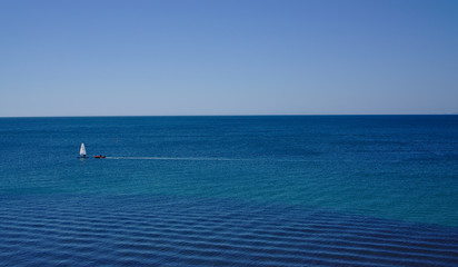 Naklejka premium Sailing boat on blue sea