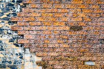 orange brick wall is crack and break and corroded by rainwater
