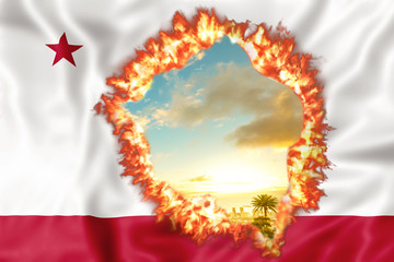 Obraz premium Fires in California in 2018. California Republic Flag on fire with sky sunset background. The fire that is affecting California is considered the most devastating and deadly ever seen in the US state.