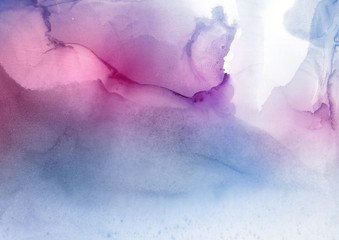 Colorful wet abstract paint leaks and splashes texture on white watercolor paper background. Natural organic shapes and design.