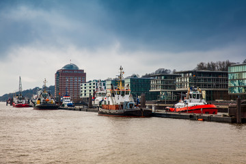 Tugboats docked at the Hamburg port on the banks of the Elbe river