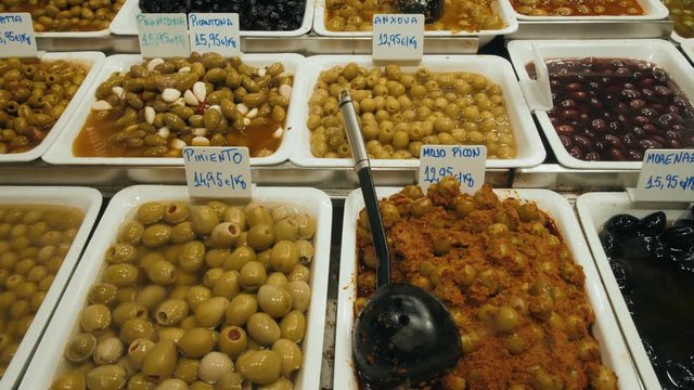 Marinated garlic and olives on provencal street market in Provence, France. Selling and buying spain spanish