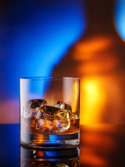 Selective focus glasses of cold whiskey